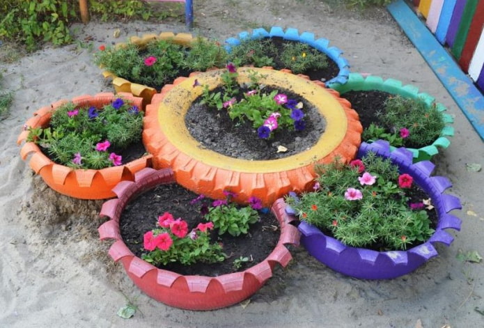 flower bed made of painted tires with carved teeth