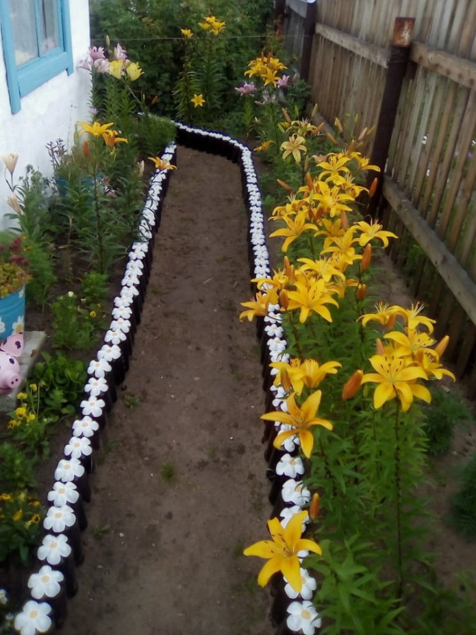 border of dug plastic bottles with painted bottoms