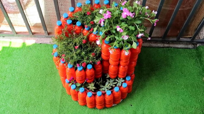 multi-tiered flower bed made of colored plastic bottles