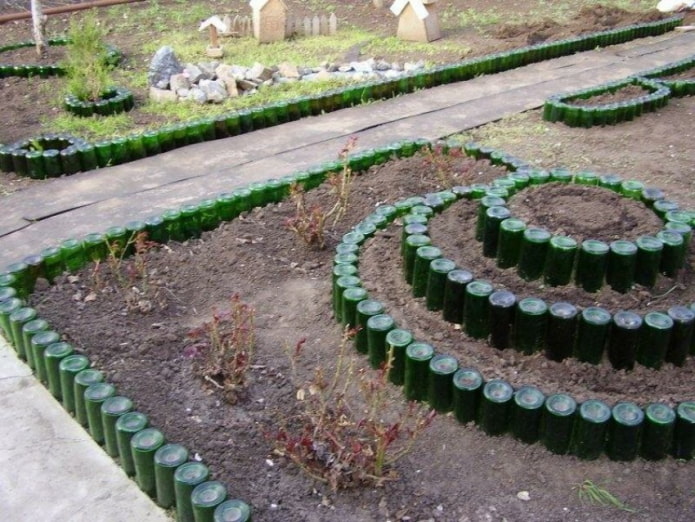 shaped border for flower beds made of inverted green glass bottles