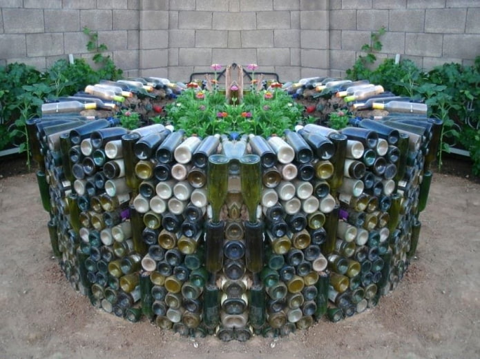 a tall flower bed of multi-colored glass bottles laid out in a circle