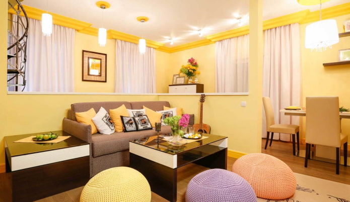 light yellow living room with multi-colored pillows and knitted ottomans light yellow living room with multi-colored pillows and knitted ottomans