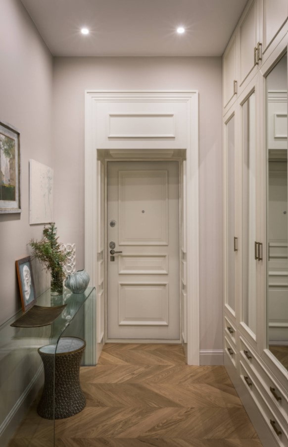 decoration of the front door with MDF panels with moldings